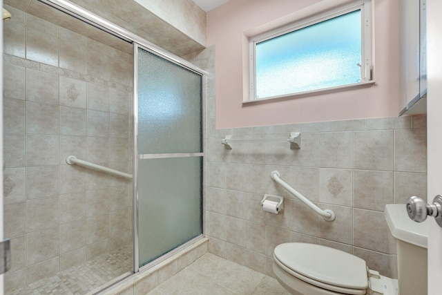 bathroom featuring an enclosed shower, tile walls, and toilet