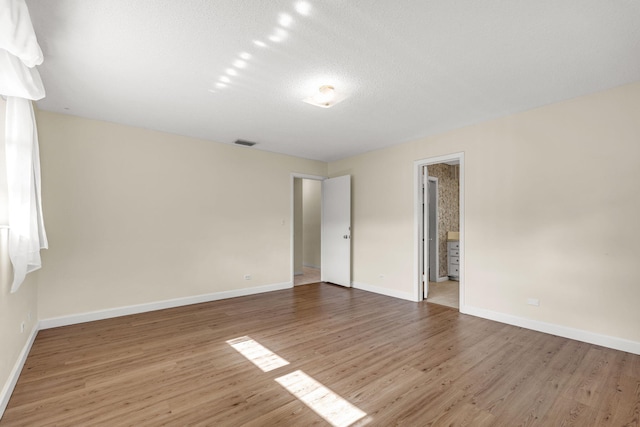 unfurnished room with hardwood / wood-style flooring