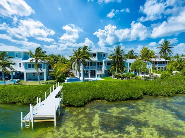 view of dock featuring a yard and a water view