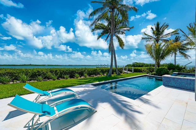 view of pool with a water view, a yard, and a patio