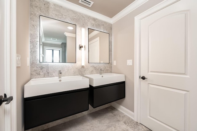 bathroom with ornamental molding and vanity