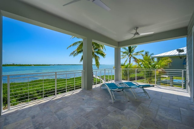 view of patio with a balcony, a water view, and ceiling fan