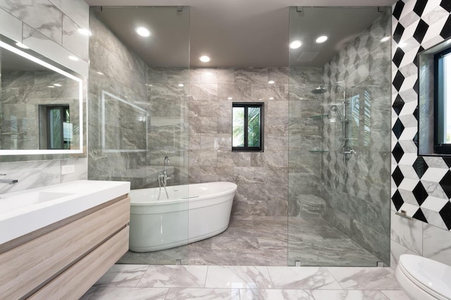 full bathroom featuring toilet, vanity, plus walk in shower, and tile walls