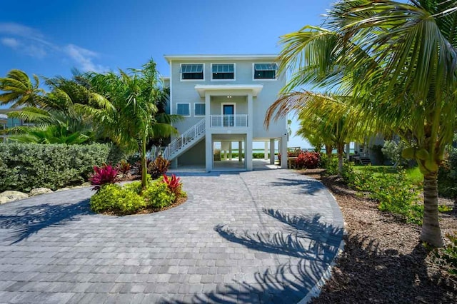 raised beach house featuring a carport