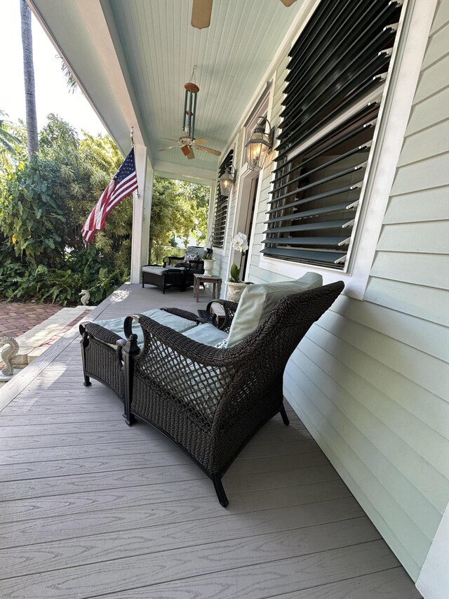 wooden deck featuring ceiling fan and covered porch