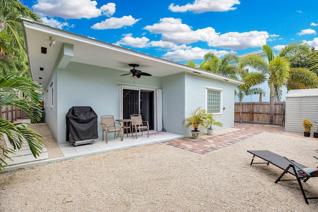 back of property with a patio area, fence, a ceiling fan, and stucco siding