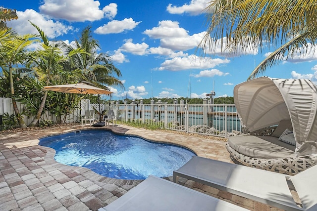 view of swimming pool with a patio area, a water view, a fenced backyard, and a fenced in pool