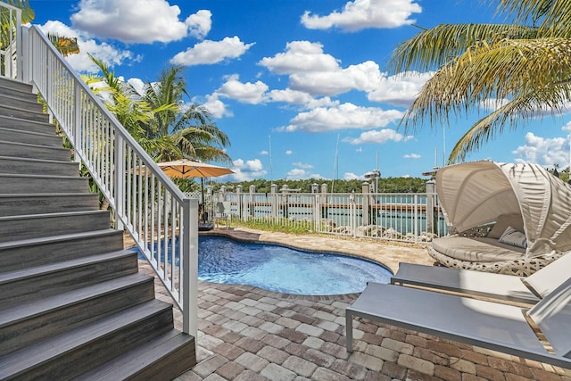 view of swimming pool with stairs, a patio area, a fenced in pool, and a water view