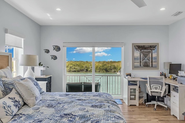 bedroom with light wood-style floors, access to outside, visible vents, and multiple windows