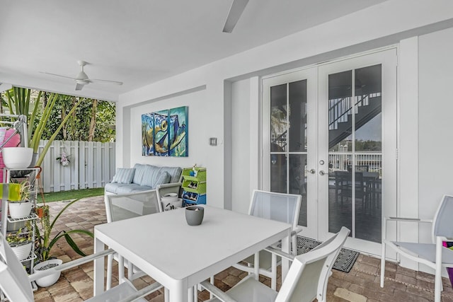 view of patio featuring a ceiling fan, outdoor dining area, and fence