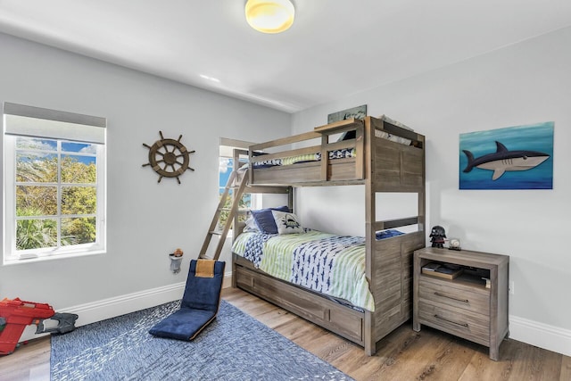 bedroom with baseboards and wood finished floors