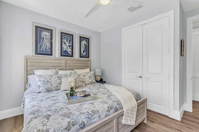 bedroom with visible vents, baseboards, and wood finished floors