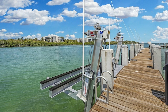 dock area with a water view and boat lift