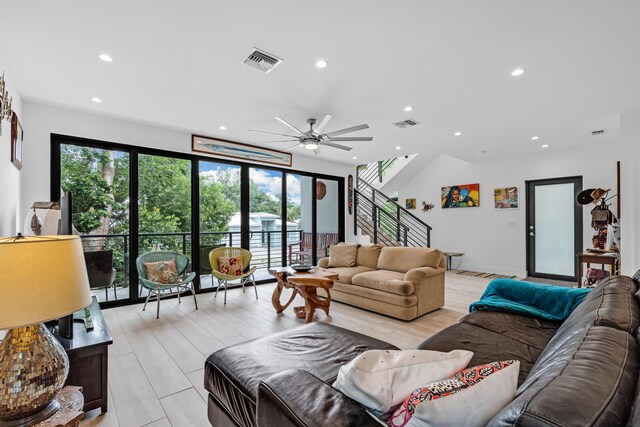 living room with ceiling fan and light hardwood / wood-style floors