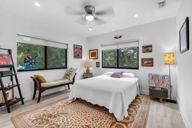 bedroom with ceiling fan and light hardwood / wood-style floors