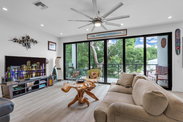 living room with plenty of natural light and light hardwood / wood-style floors