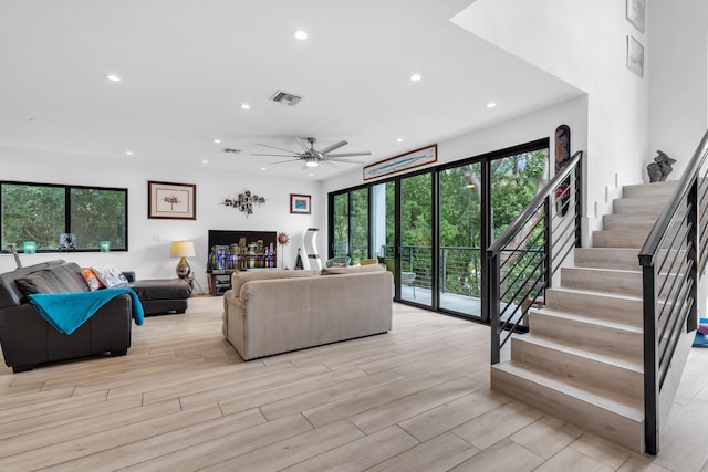 living room featuring ceiling fan and light hardwood / wood-style flooring