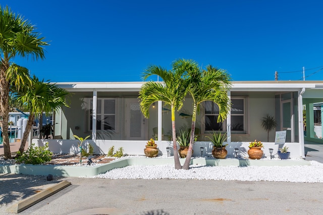 view of front of home featuring a sunroom