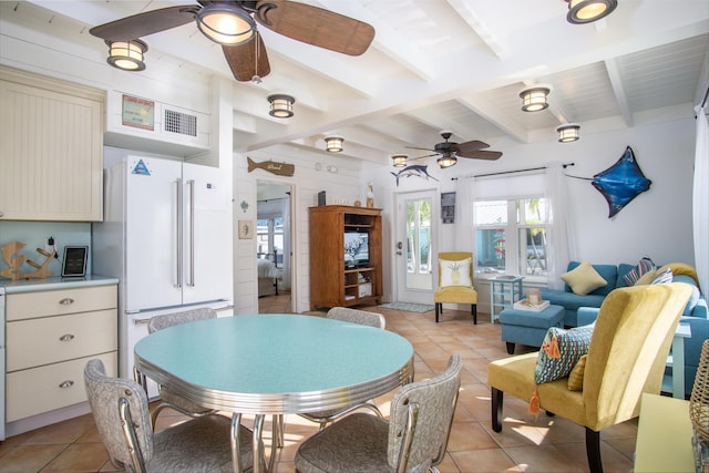 tiled dining space with beamed ceiling and ceiling fan