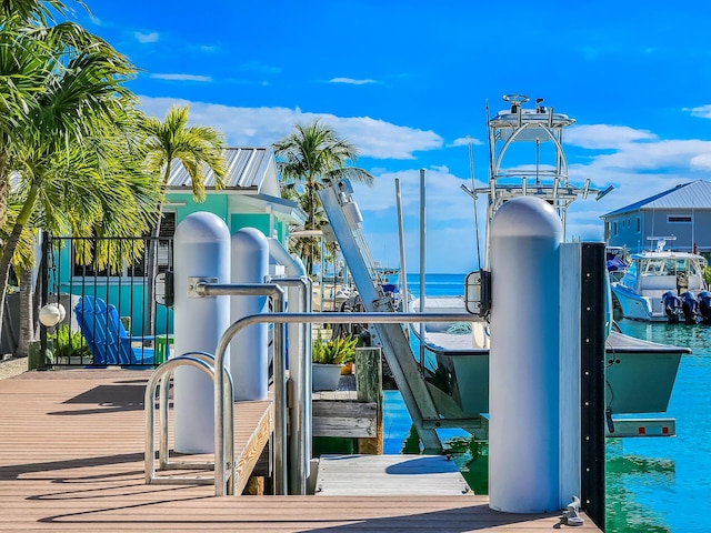 view of playground featuring a water view and a dock