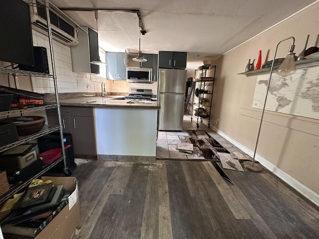 1014 Varela St Unit 3, Key West, FL 33040 - kitchen featuring a peninsula, wood finished floors, tasteful backsplash, appliances with stainless steel finishes, and a sink
