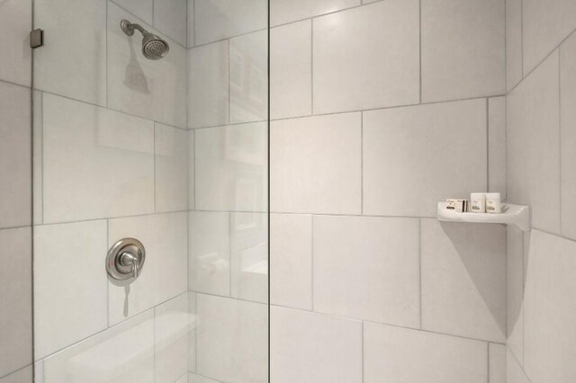 interior details featuring a tile shower