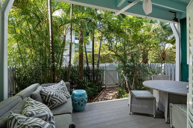 wooden terrace featuring ceiling fan