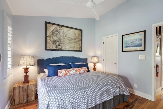 bedroom with hardwood / wood-style flooring and vaulted ceiling