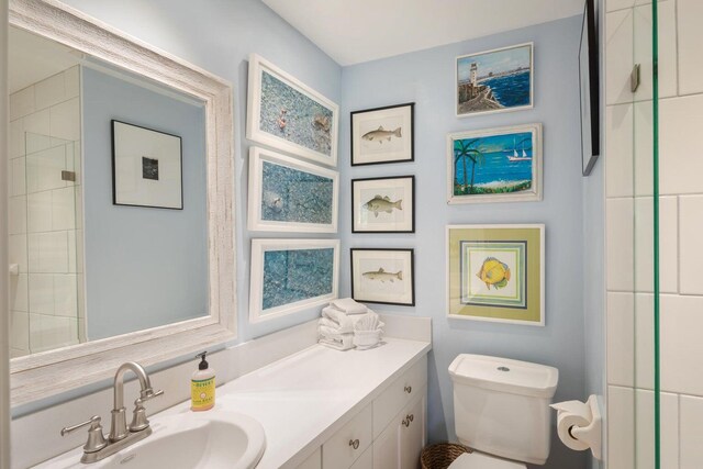 bathroom featuring vanity, toilet, and a shower