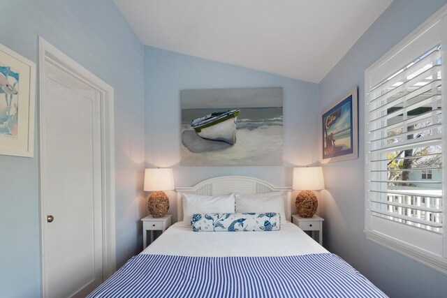 bedroom featuring lofted ceiling