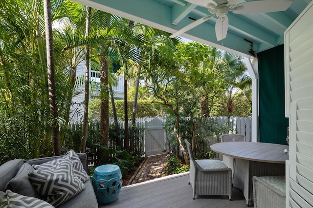 sunroom with beamed ceiling and ceiling fan