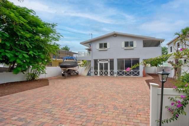 15 Garden Cove Dr, Key Largo, FL 33037 - rear view of property with a fenced backyard, a balcony, stucco siding, and a patio area
