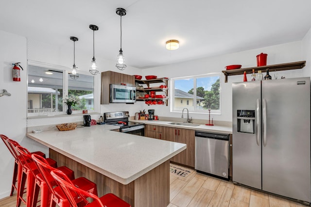 15 Garden Cove Dr, Key Largo, FL 33037 - kitchen with appliances with stainless steel finishes, a sink, a peninsula, and light countertops