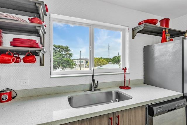 15 Garden Cove Dr, Key Largo, FL 33037 - kitchen featuring appliances with stainless steel finishes, a sink, wallpapered walls, and light stone counters