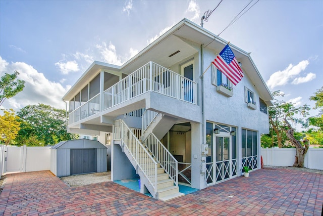15 Garden Cove Dr, Key Largo, FL 33037 - back of property with a fenced backyard, a patio, stucco siding, stairway, and a gate