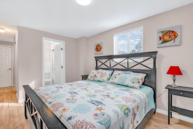 15 Garden Cove Dr, Key Largo, FL 33037 - bedroom with light wood-type flooring, baseboards, and connected bathroom