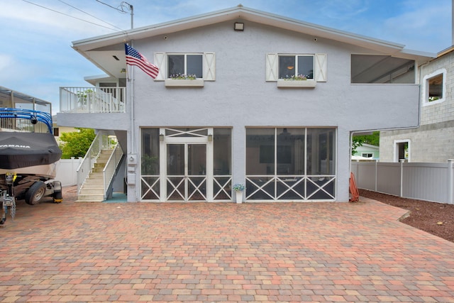 15 Garden Cove Dr, Key Largo, FL 33037 - back of property with stucco siding and stairs