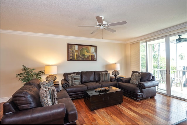 living room featuring hardwood / wood-style floors, ornamental molding, ceiling fan, a textured ceiling, and french doors