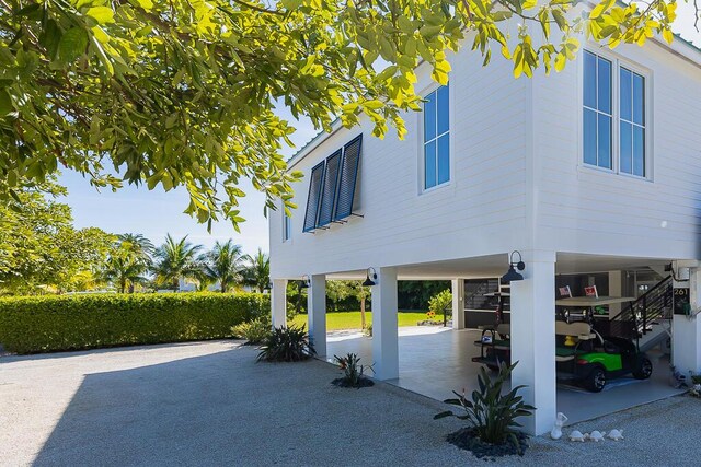 261 W Seaview Dr, Duck, FL 33050 - view of patio with stairs and a carport