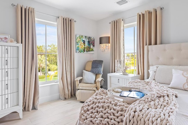 261 W Seaview Dr, Duck, FL 33050 - bedroom with multiple windows, light wood finished floors, and baseboards