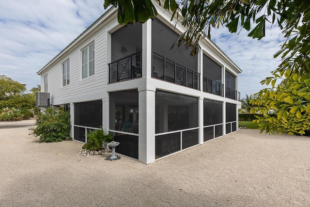 261 W Seaview Dr, Duck, FL 33050 - view of property exterior with a balcony, a sunroom, stucco siding, and central air condition unit