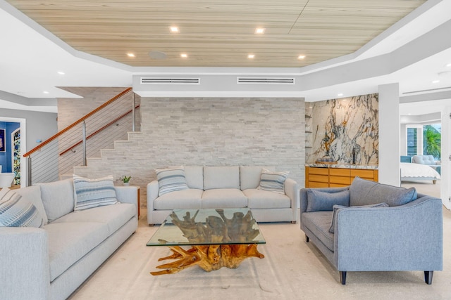 living room featuring a raised ceiling and wood ceiling