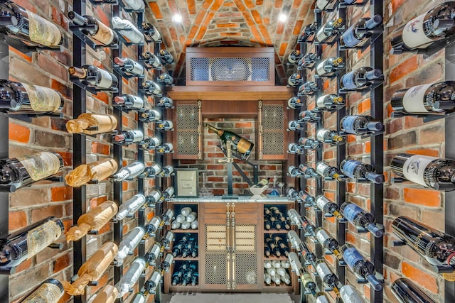 wine room featuring brick ceiling and brick wall