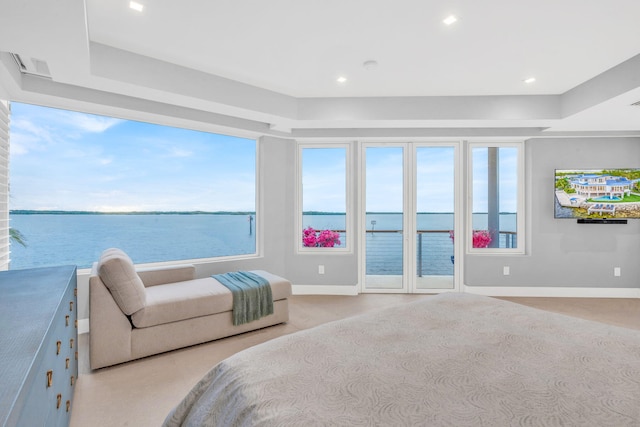 carpeted bedroom featuring access to exterior and a water view