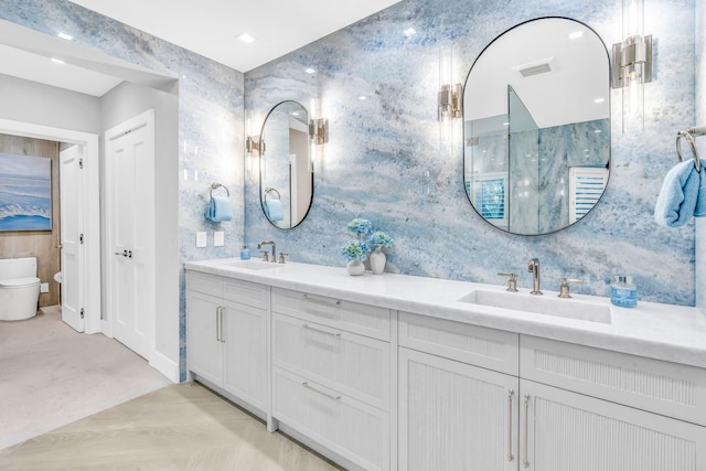 bathroom featuring vanity and toilet