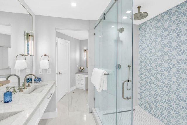 bathroom featuring a shower with door and vanity