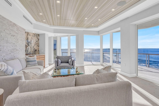 living room featuring a water view, a raised ceiling, and wooden ceiling