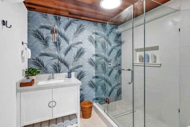 bathroom with vanity, a shower with door, and wooden ceiling