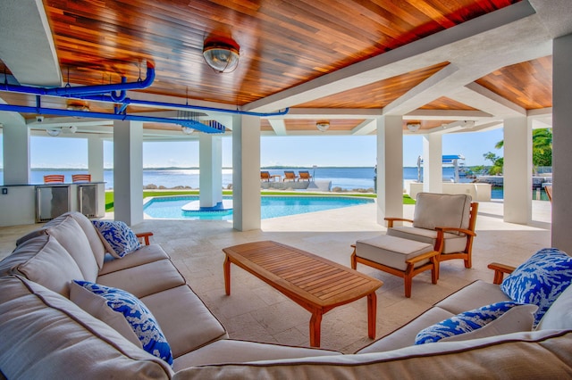 view of patio / terrace with a water view and an outdoor living space