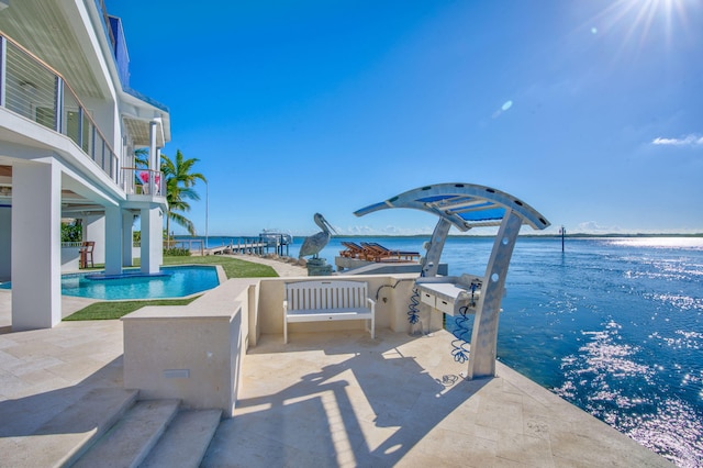 exterior space with a patio and a water view